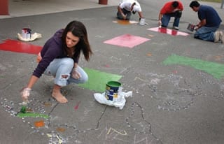 Porterville students paint the Peaceful Playground Learning and playing on the playground.